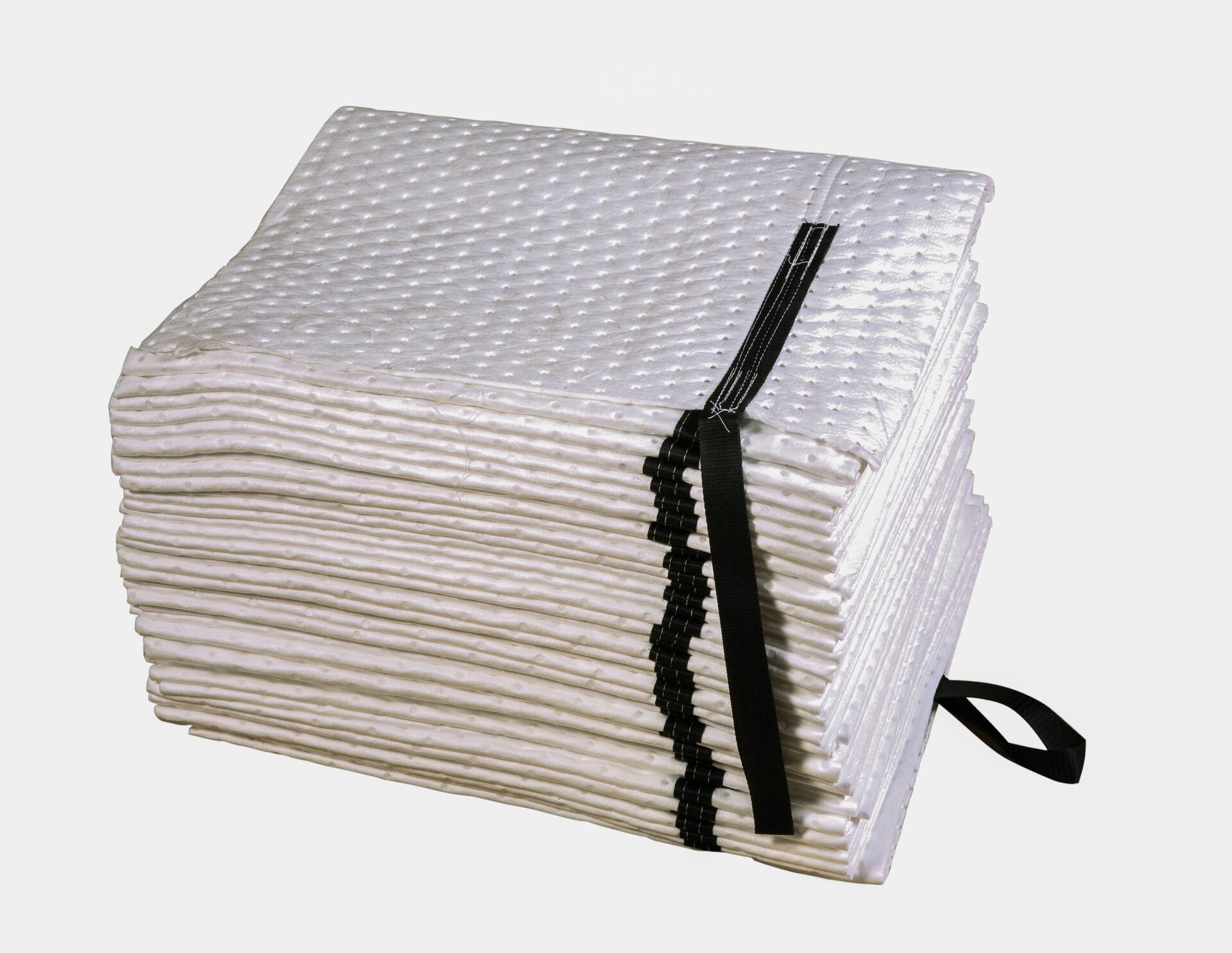 Stack of white absorbent pads with black straps